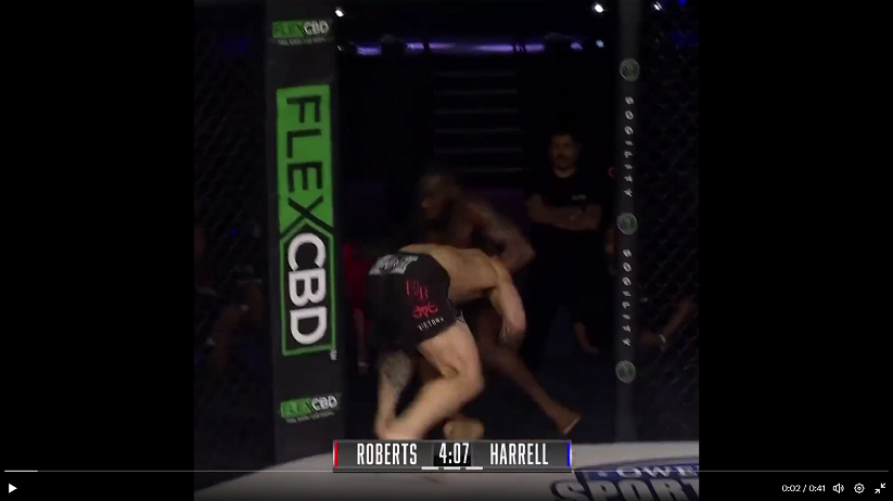 Video – Fighter double legs opponent through cage door, wins by TKO